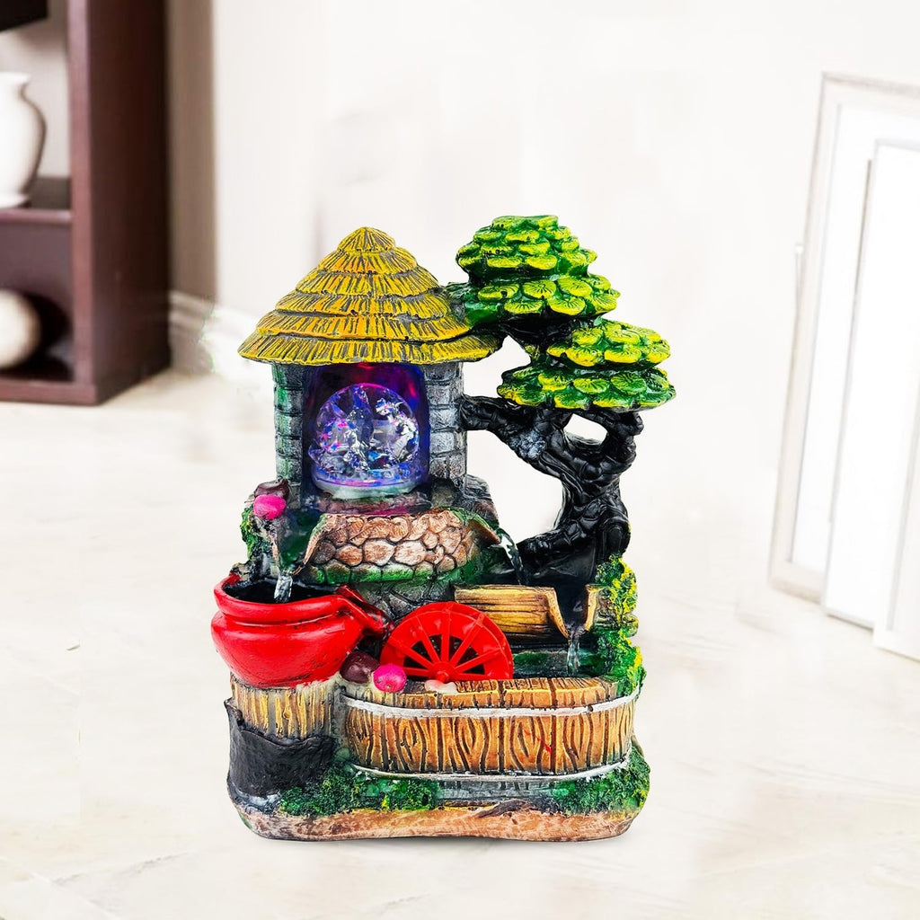 GoHooked multicolour polyresin waterfall fountain with LED lights and adjustable speed control, featuring a thatched roof house and tree.