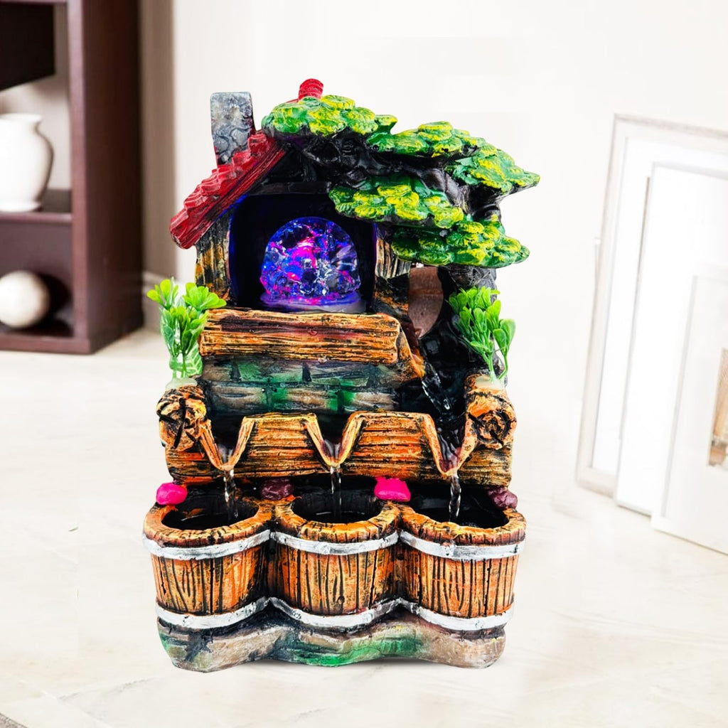 GoHooked multicolour polyresin waterfall fountain with LED lights and adjustable speed control, featuring a rustic house and tree design with three wooden buckets.