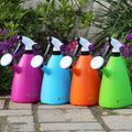 GoHooked dual-use watering can and spray bottle in assorted bright colors: pink, blue, orange, and green.