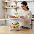 Go Hooked white 2-tier metal mesh countertop basket holding fruits and vegetables. Modern kitchen storage.