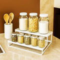 GoHooked white 2-tier metal standing rack organizer holding jars of spices and dry goods.