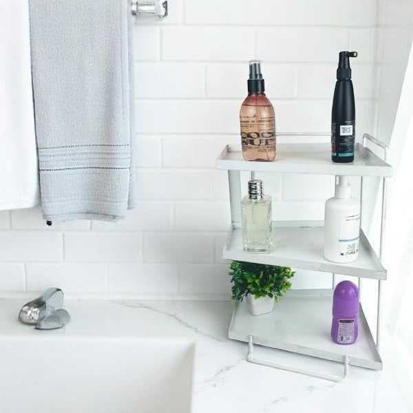 GoHooked white 3-tier iron countertop storage organizer with toiletries and a small plant.