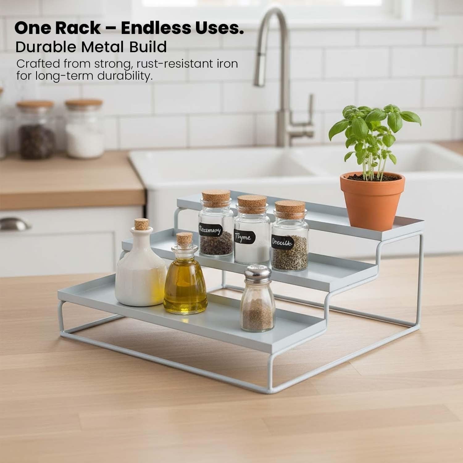 GoHooked white 3-tier metal spice rack organizer for kitchen counter or cabinet. Holds jars, bottles, and a potted herb.