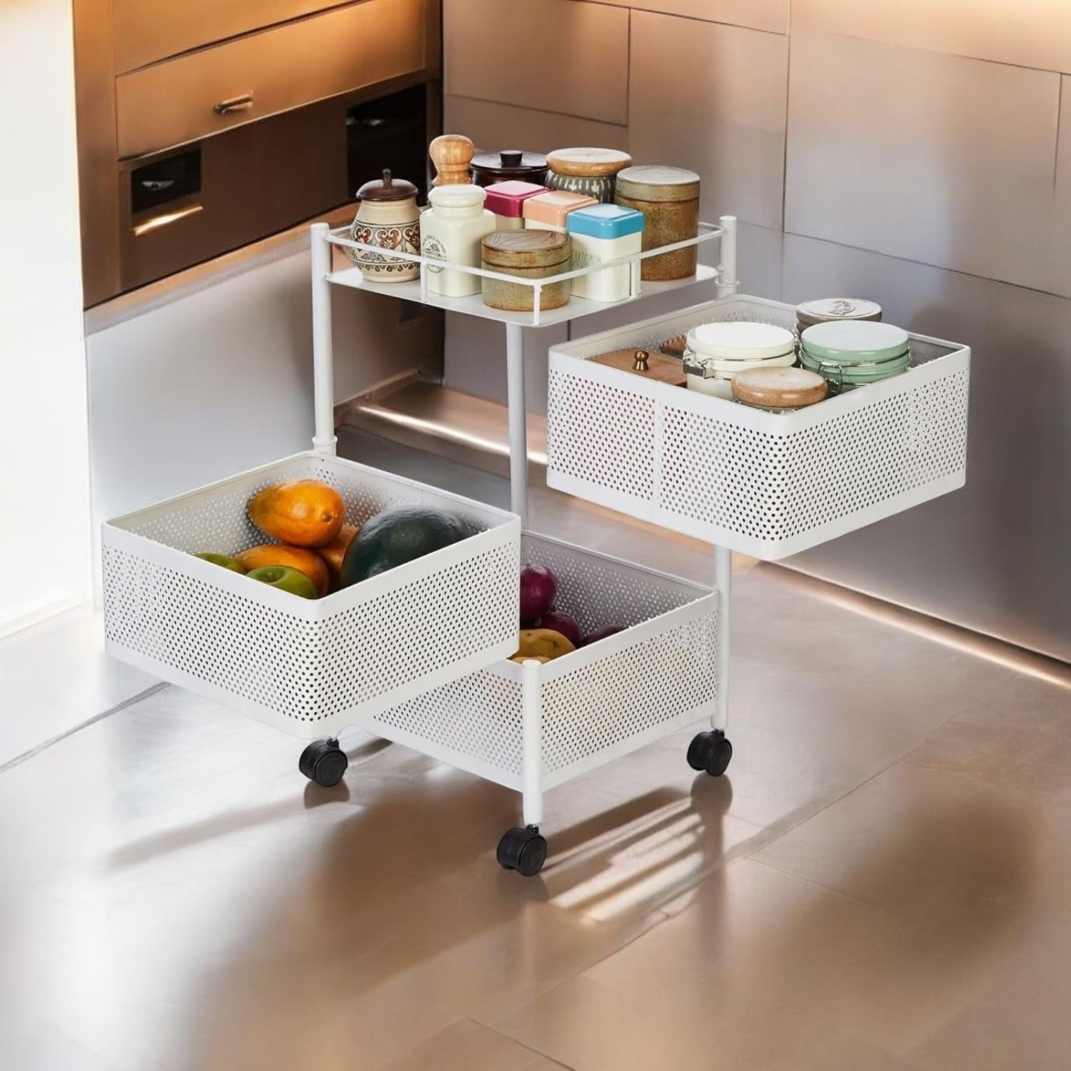Go Hooked white 3-tiered rotating metal storage cart with baskets filled with fruits and jars on top shelf.