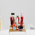 GoHooked white 3-tier wooden shelf organizer displaying various toiletries and cosmetics. Includes a toothbrush in a glass.