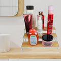 GoHooked white 3-tier wooden shelf organizer with metal frame, holding various bottles and jars of toiletries and cosmetics.