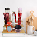 GoHooked white 3-tier wooden shelf organizer with metal frame, holding various bottles and jars of toiletries and cosmetics.