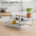 GoHooked white 3-tier metal step spice rack organizer with spice jars, oil bottles, and a potted plant.