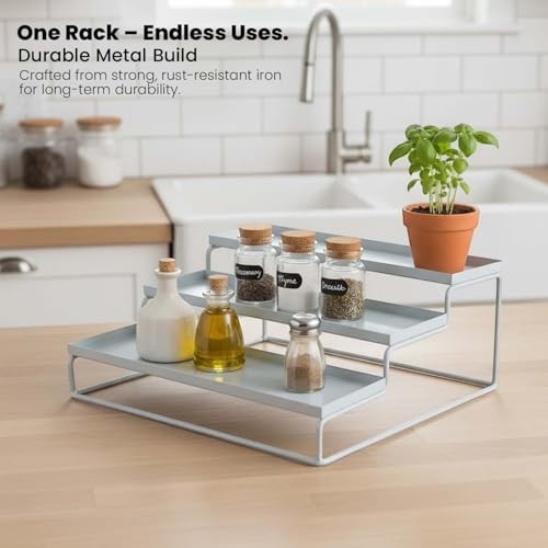GoHooked white 3-tier metal step spice rack organizer with spice jars, oil bottles, and a potted plant.