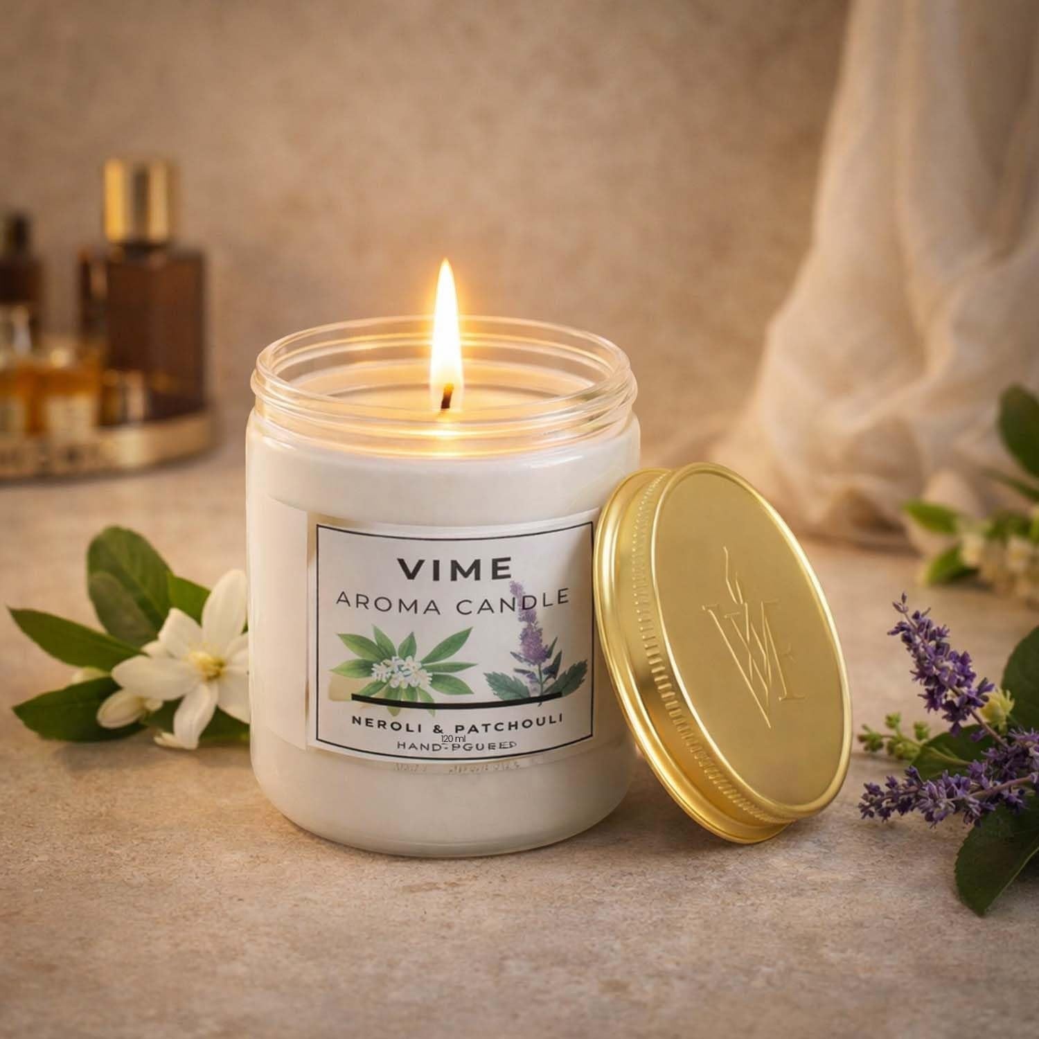 GoHooked white wax aroma candle in a glass jar with a gold lid, scented with Neroli & Patchouli.