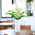 GoHooked white artificial baby's breath flowers in a textured white vase, perfect for wedding bouquets and home decor.
