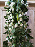 GoHooked white artificial hanging flower garland with green leaves, 35 inches long, perfect for home and party decor.
