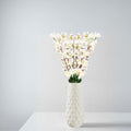 Go Hooked white artificial flowers in a textured white ceramic vase, perfect for home or office decor.