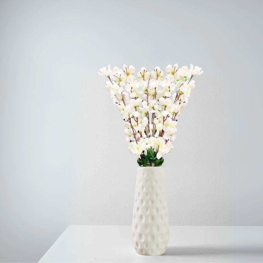 Go Hooked white artificial flowers in a textured white ceramic vase, perfect for home or office decor.