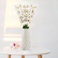 GoHooked white artificial flowers in a textured white ceramic vase, realistic faux blossoms for home decor.