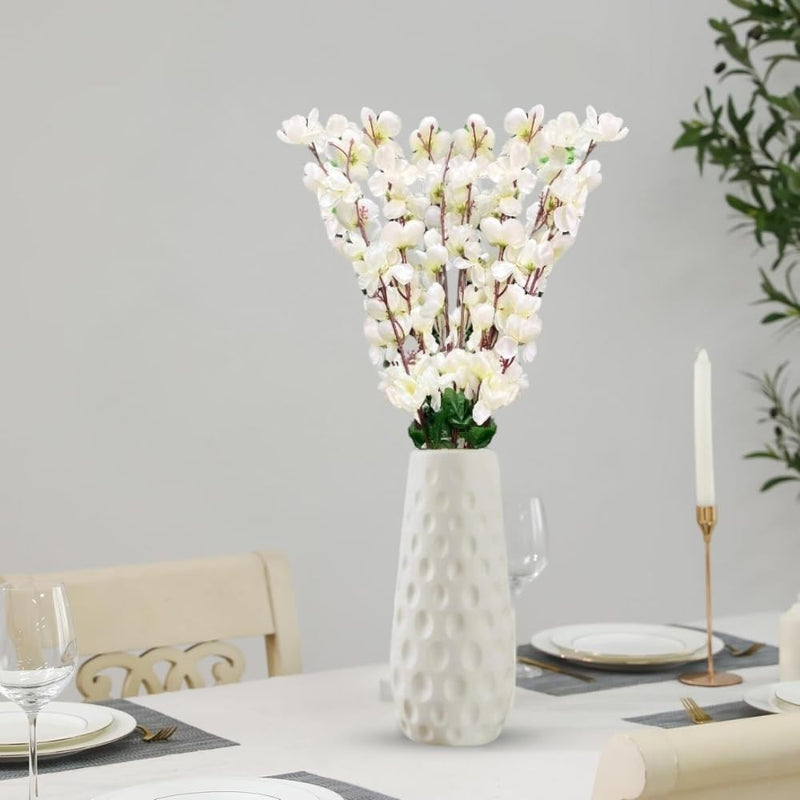 Go Hooked white artificial flowers in a textured white ceramic vase, perfect for home or office decor.