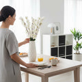 GoHooked white artificial flowers in a textured white vase on a dining table, styled for home decor.