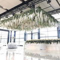 GoHooked white artificial wisteria silk flowers cascading from ceiling installation at wedding venue