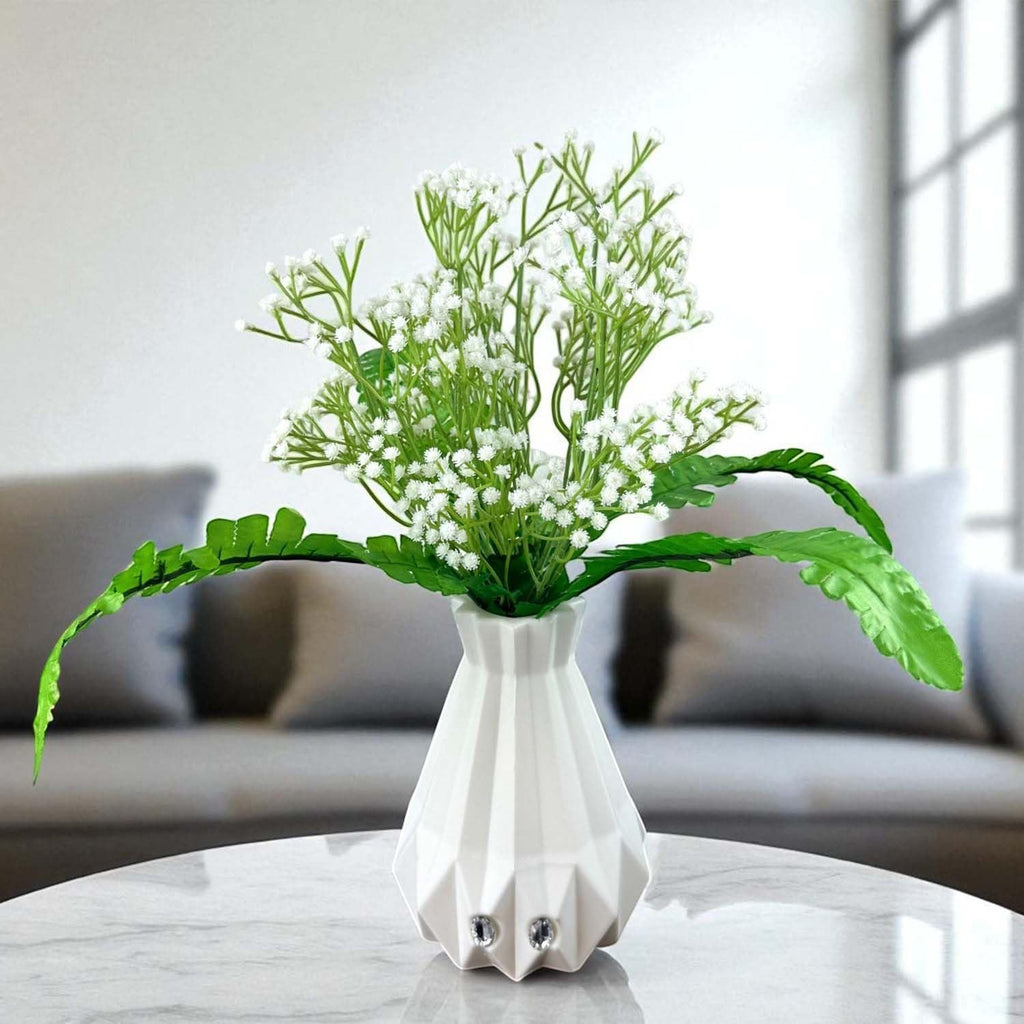 Go Hooked white baby's breath artificial flowers with fern leaves in a geometric white vase.