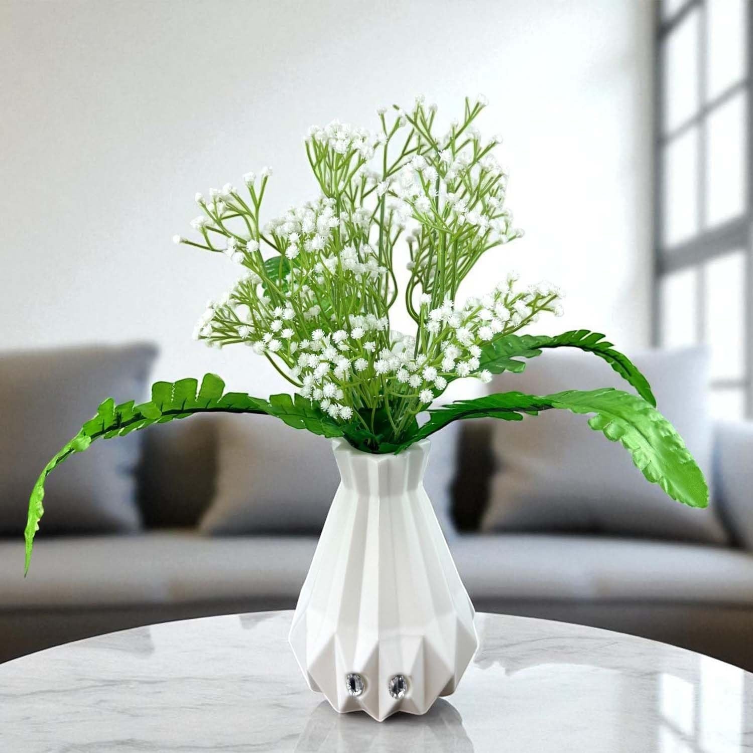 Go Hooked white baby's breath artificial flowers with fern leaves in a geometric white vase.