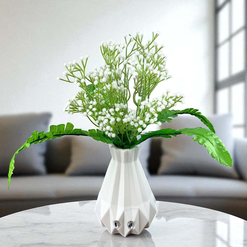 Go Hooked white baby's breath artificial flowers with fern leaves in a geometric white vase.