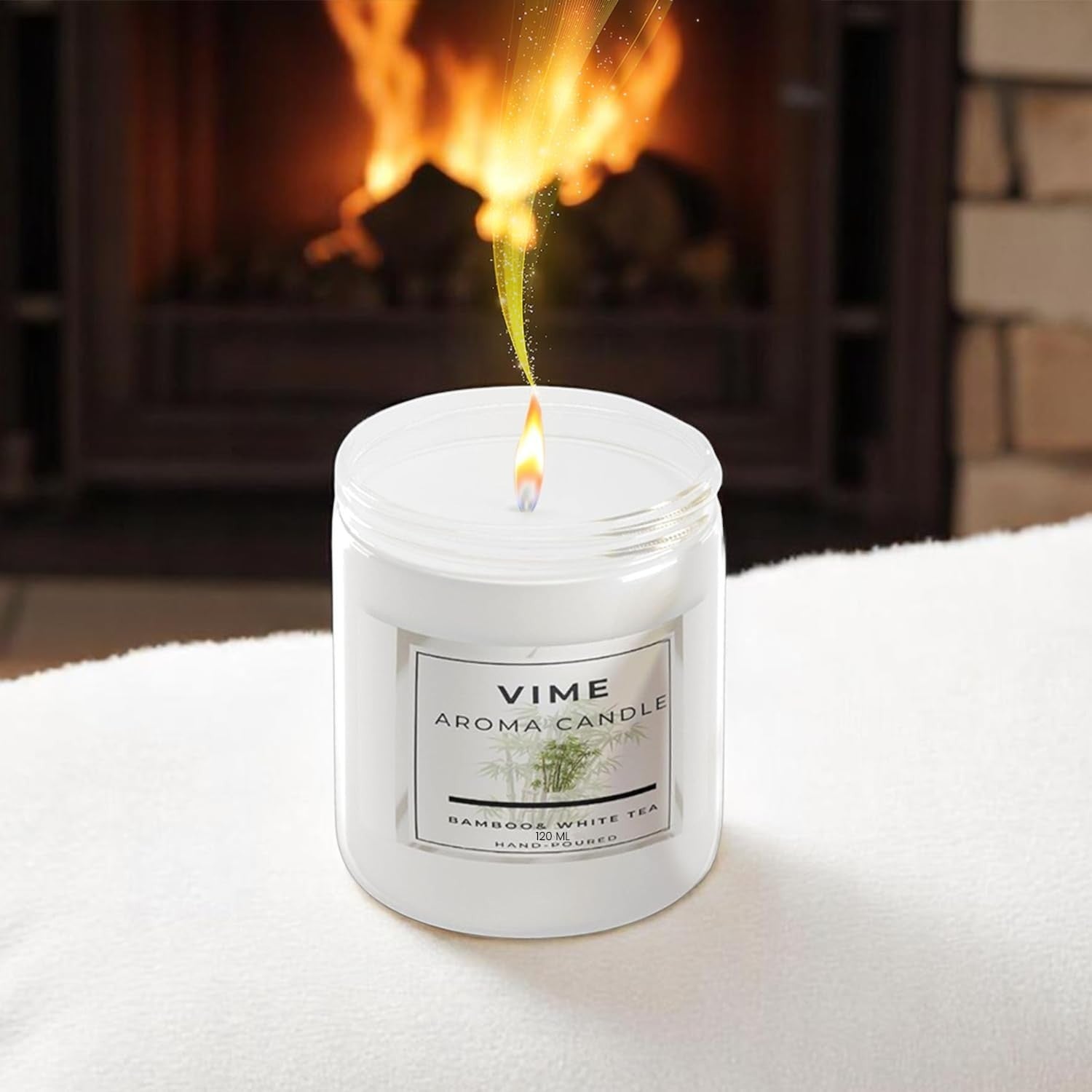 GoHooked white bamboo & white tea scented aroma candle in a glass jar, burning with a warm flame.