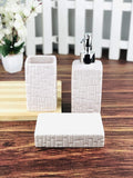 Go Hooked white ceramic 3-piece bathroom set with textured geometric pattern. Includes soap dispenser, toothbrush holder, and soap dish.
