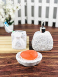 GoHooked white ceramic 3-piece bathroom set with rose detailing, includes soap dish, soap dispenser, and toothbrush holder.