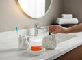 GoHooked white ceramic 3-piece bathroom set with rose and dress motifs, includes soap dispenser, toothbrush holder, and soap dish.