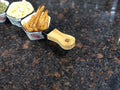 Go Hooked white ceramic snack serving bowl with bamboo handle, filled with french fries.