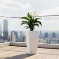 GoHooked white 18-inch tall geometric polymer planter with a peace lily plant on a balcony.