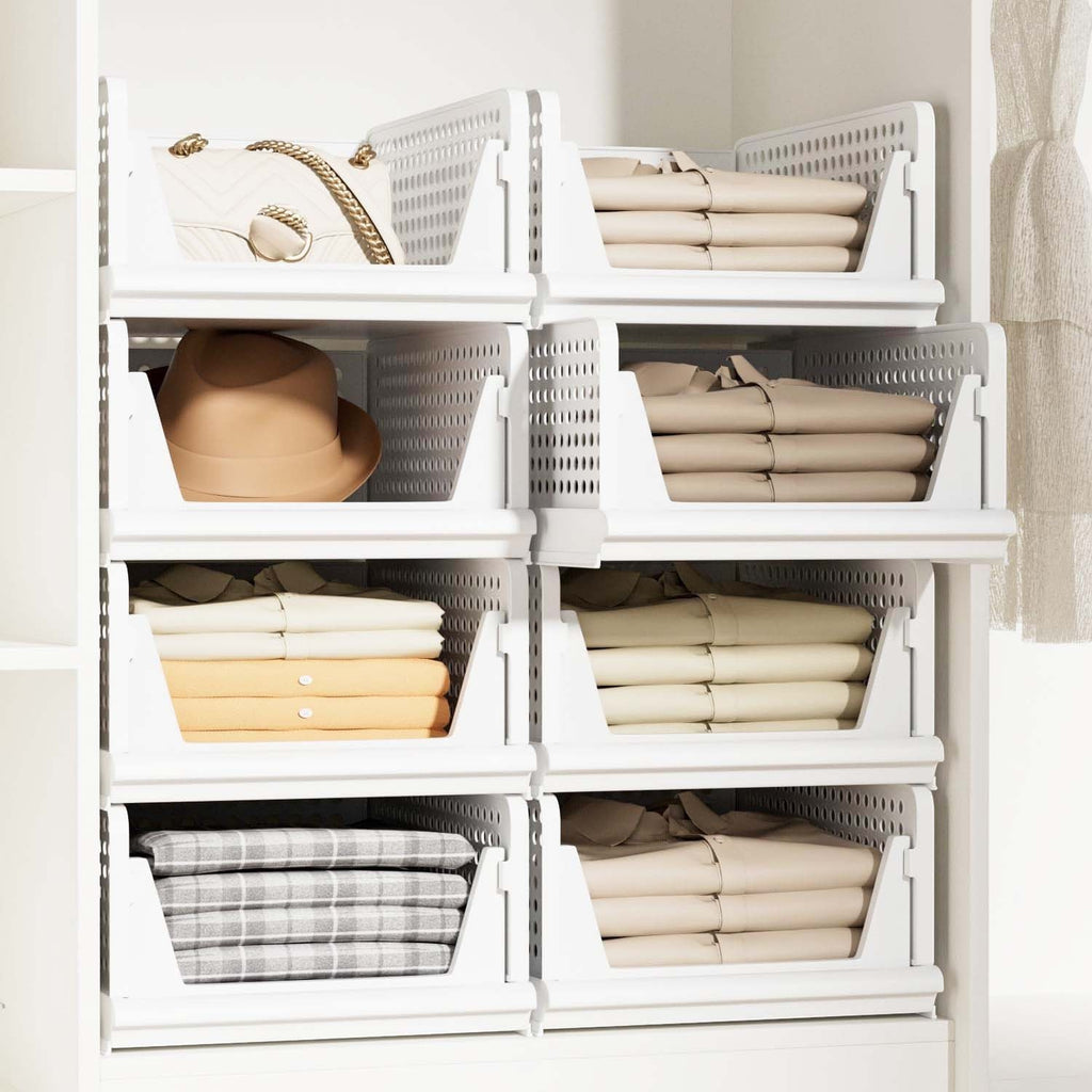 GoHooked white foldable plastic wardrobe organizers stacked in a cupboard with clothes, a hat, and a handbag.