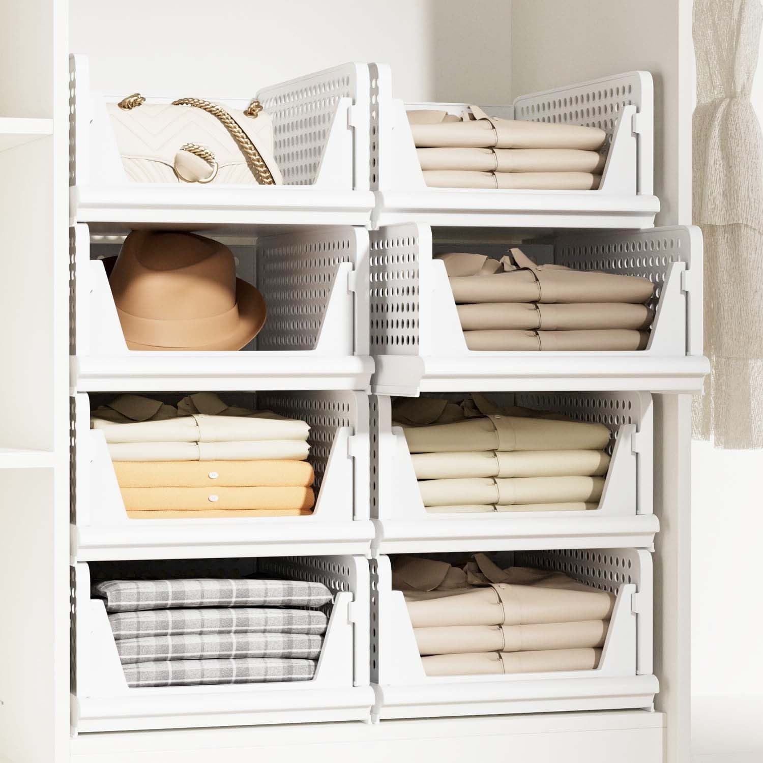 GoHooked white foldable plastic wardrobe organizers stacked in a cupboard with clothes, a hat, and a handbag.