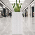 GoHooked white tall square polymer planter with granite ribbed design and snake plant.