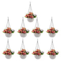 GoHooked white plastic hanging pots with woven texture, 7.1 inch diameter, set of 9. Filled with pink and purple flowers.