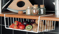 GoHooked white coated iron under shelf basket organizer rack filled with fruits like strawberries, apples, plums, and kiwis.