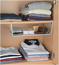 GoHooked white iron under shelf basket organiser for home storage, holding folded clothes, wallet, and belt.