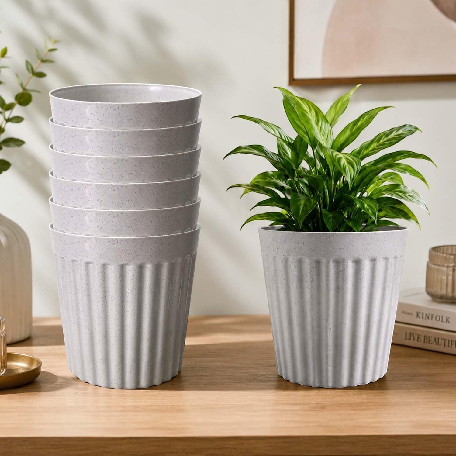 GoHooked set of three white marble-textured plastic planter pots with a modern ribbed design on a wooden table.