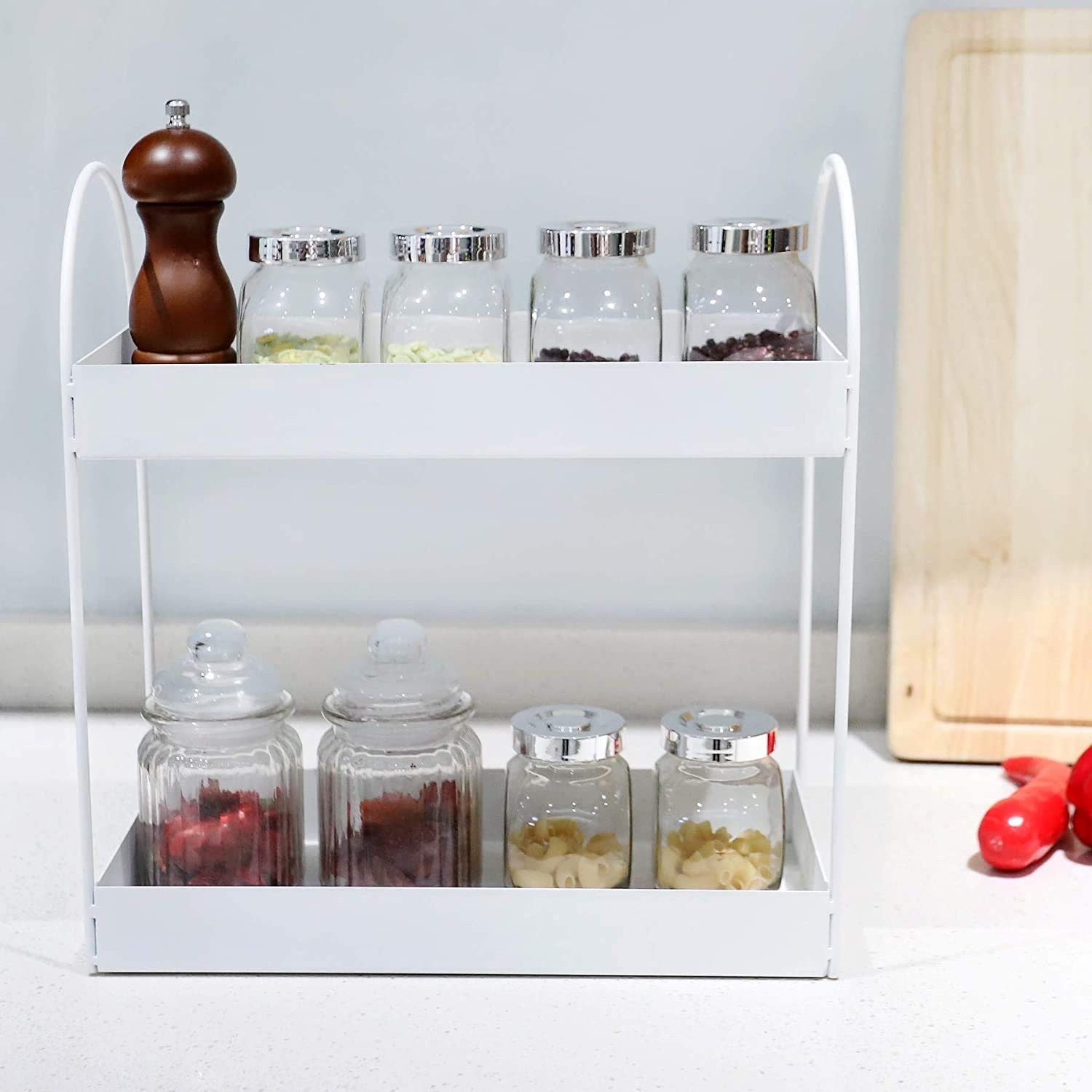 GoHooked white metal 2-tier standing rack organizer holding jars of spices and pasta. Modern design.