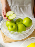 GoHooked white metal mesh fruit bowl holding fresh green apples on a wooden kitchen counter