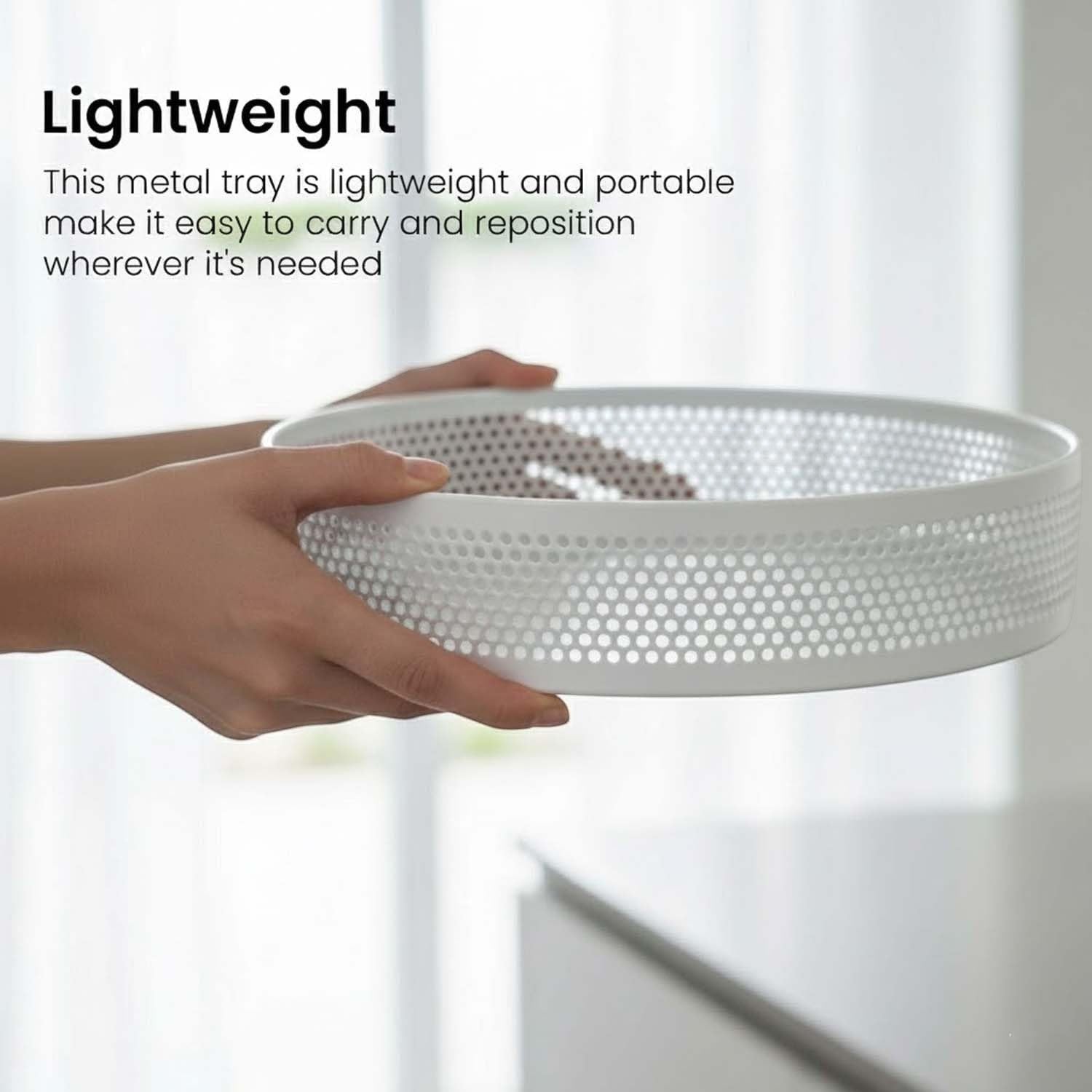 Go Hooked white metal revolving fruit basket with perforated sides and a lazy susan base.