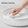 GoHooked white round metal storage tray with perforated sides and side handles, being wiped clean.