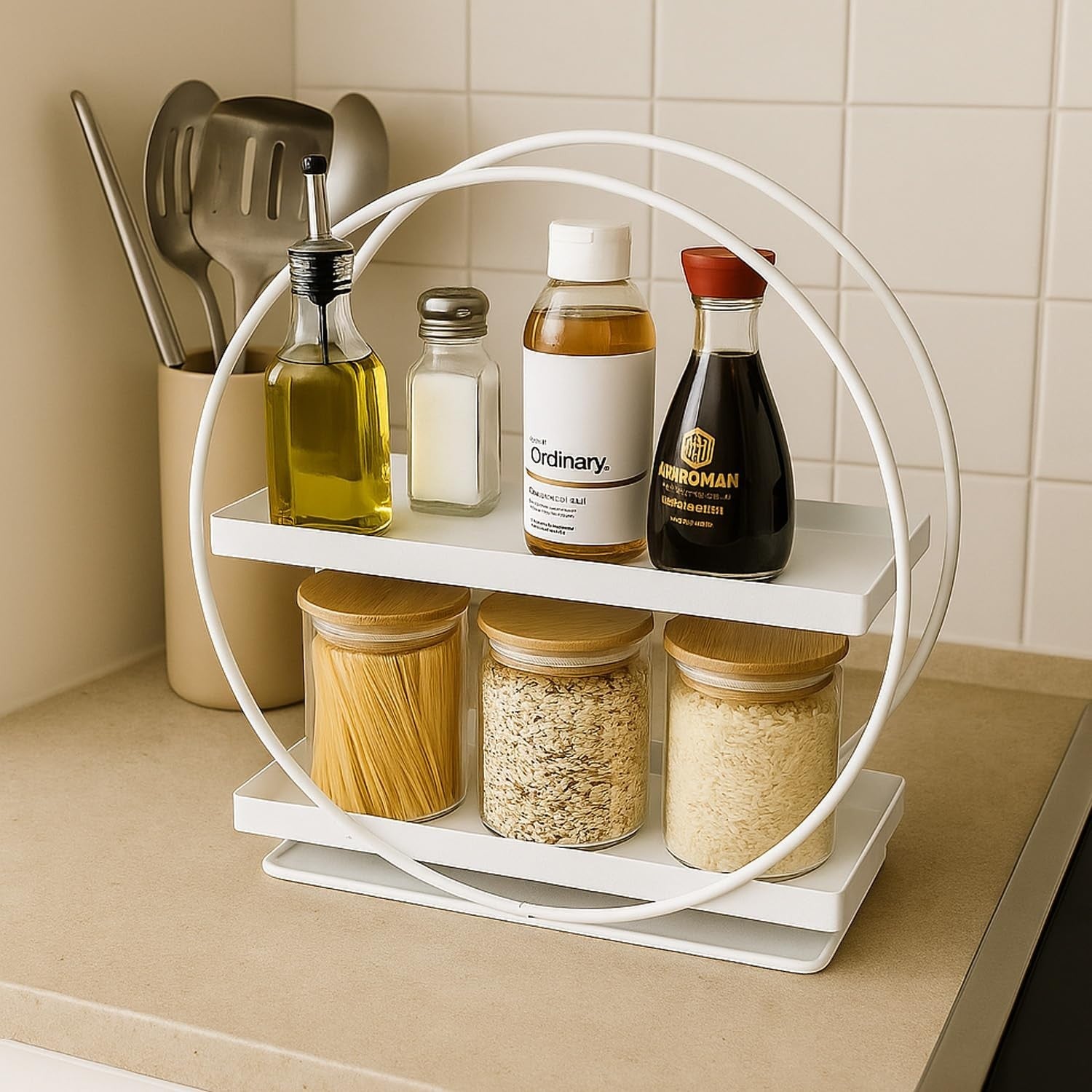 GoHooked white 2-tier metal vanity storage organizer with bamboo-lidded jars and bottles on countertop.