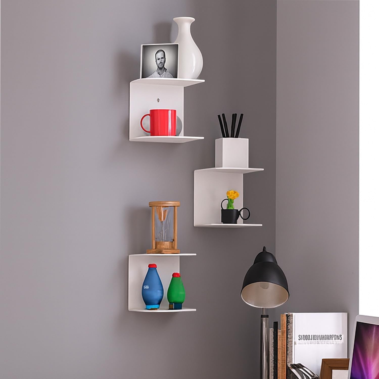 Go Hooked white metal wall mounted shelves displaying a vase, photo frame, mug, and decorative items.