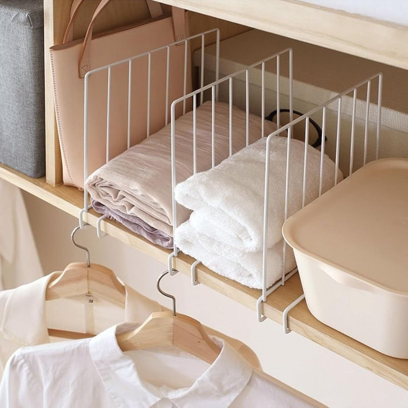 GoHooked white metal wardrobe shelf dividers organizing folded clothes and towels on a wooden shelf.