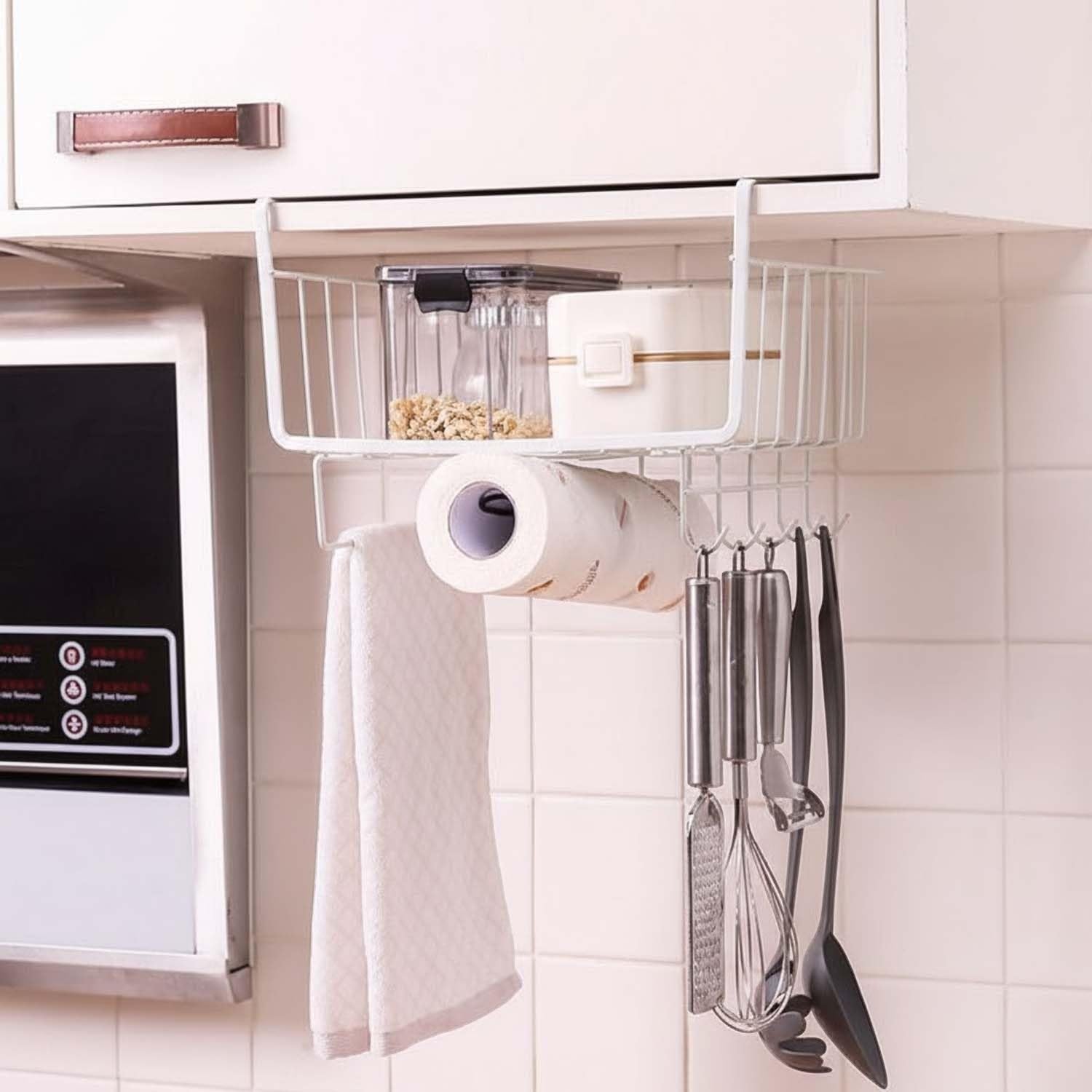 GoHooked white metal wire under shelf hanging basket organizer with hooks holding paper towels and kitchen utensils.