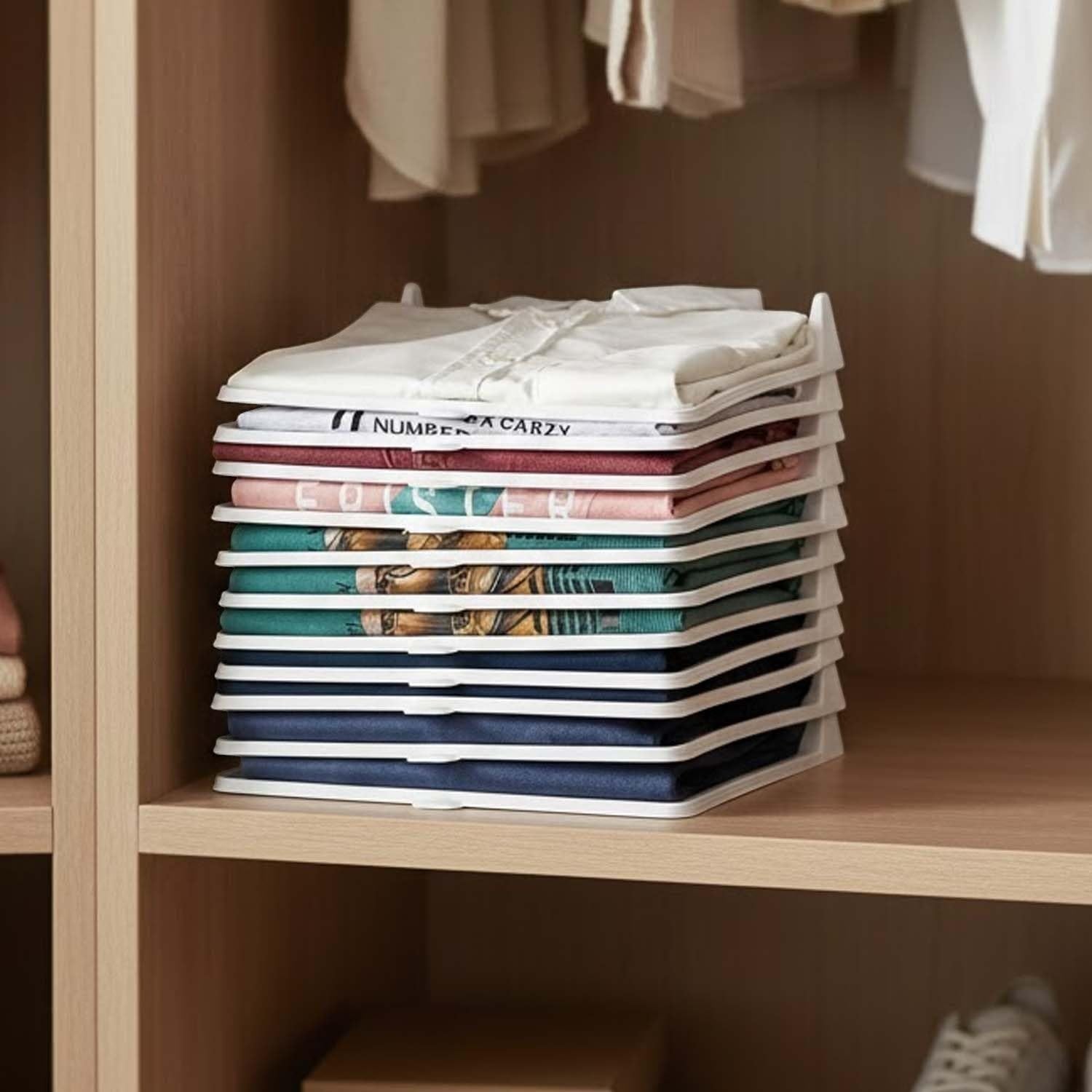GoHooked white plastic stackable clothes organizer trays neatly holding folded shirts and tops in a closet.
