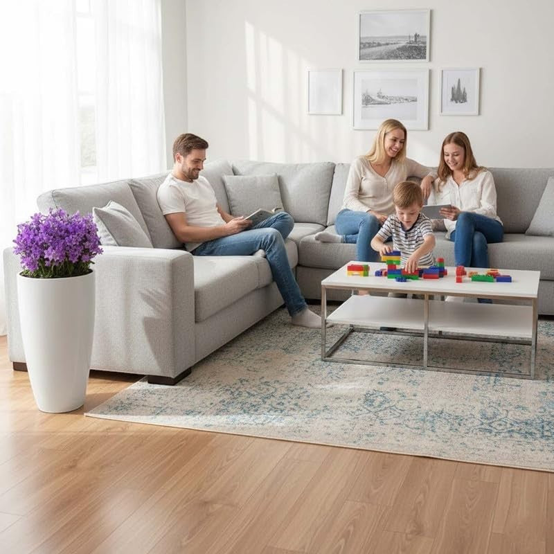 Go Hooked tall white plastic flower pot with purple flowers in a modern living room setting.