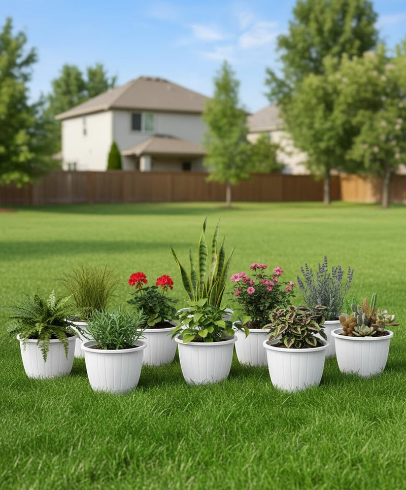 GoHooked white 10-inch plastic flower pots with fluted design, arranged with various plants on a lawn.