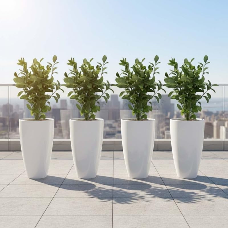 Go Hooked pack of 4 white 14-inch tall plastic flower pots with green plants on a balcony with city view.